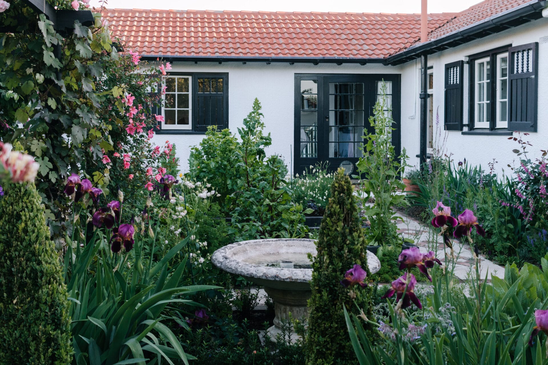 Mapuna’s secret garden delights with a rustic shed, potager beds and white stone paths;