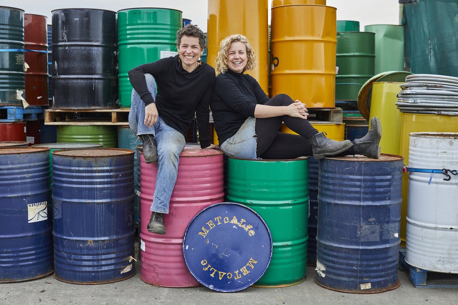 Metal Metcalfe- Amy and Katie with some of their salvaged 44-gallon steel drums, ready for repurposing. Metal Metcalfe