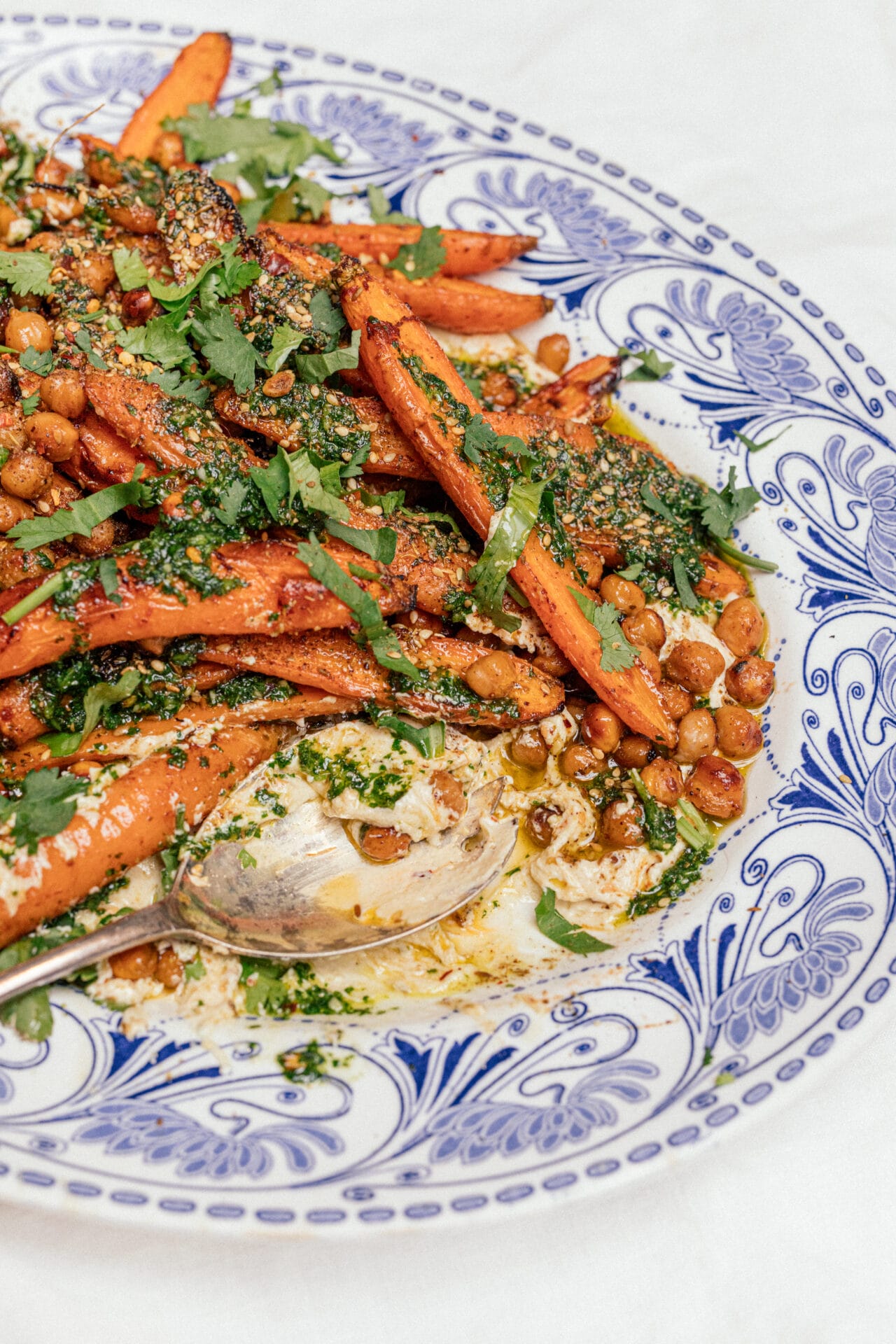 Two Raw Sisters, Harissa Carrots, Whipped Feta + Herb Carrot Top Oil