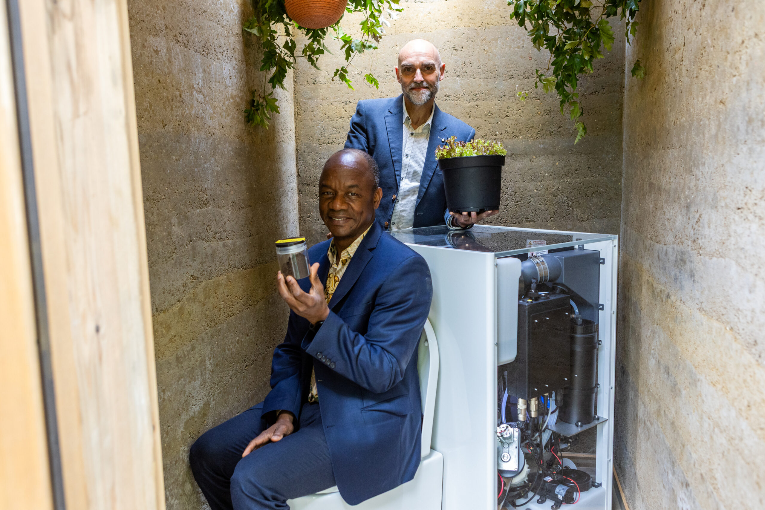 Gates Foundation's Garden of The Future at RHS Chelsea, by Butler & Parker. Doulaye Kone and Matt Collins with the Cranfield Circular Toilet