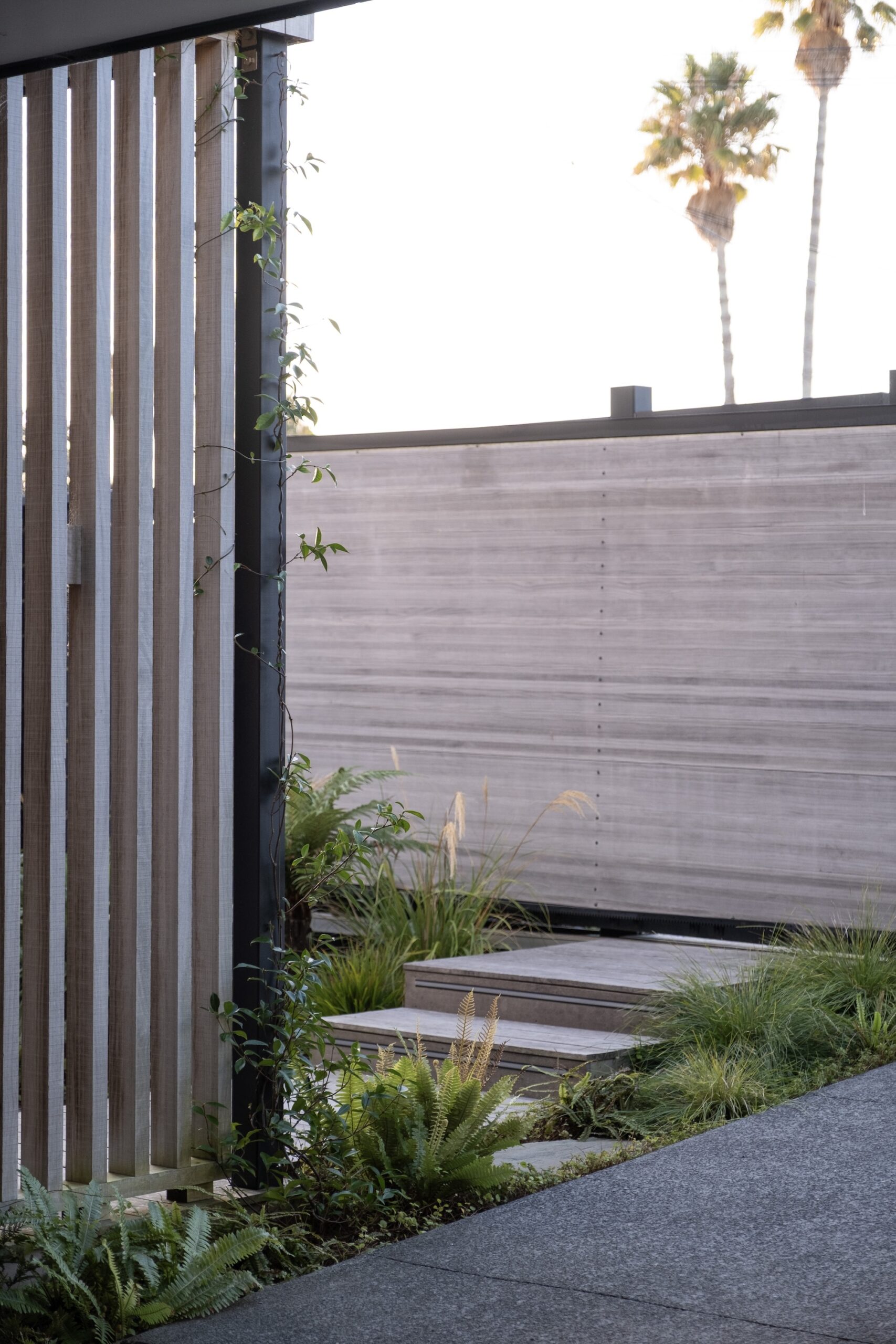 Entry gate leading into a minimalist modern landscape