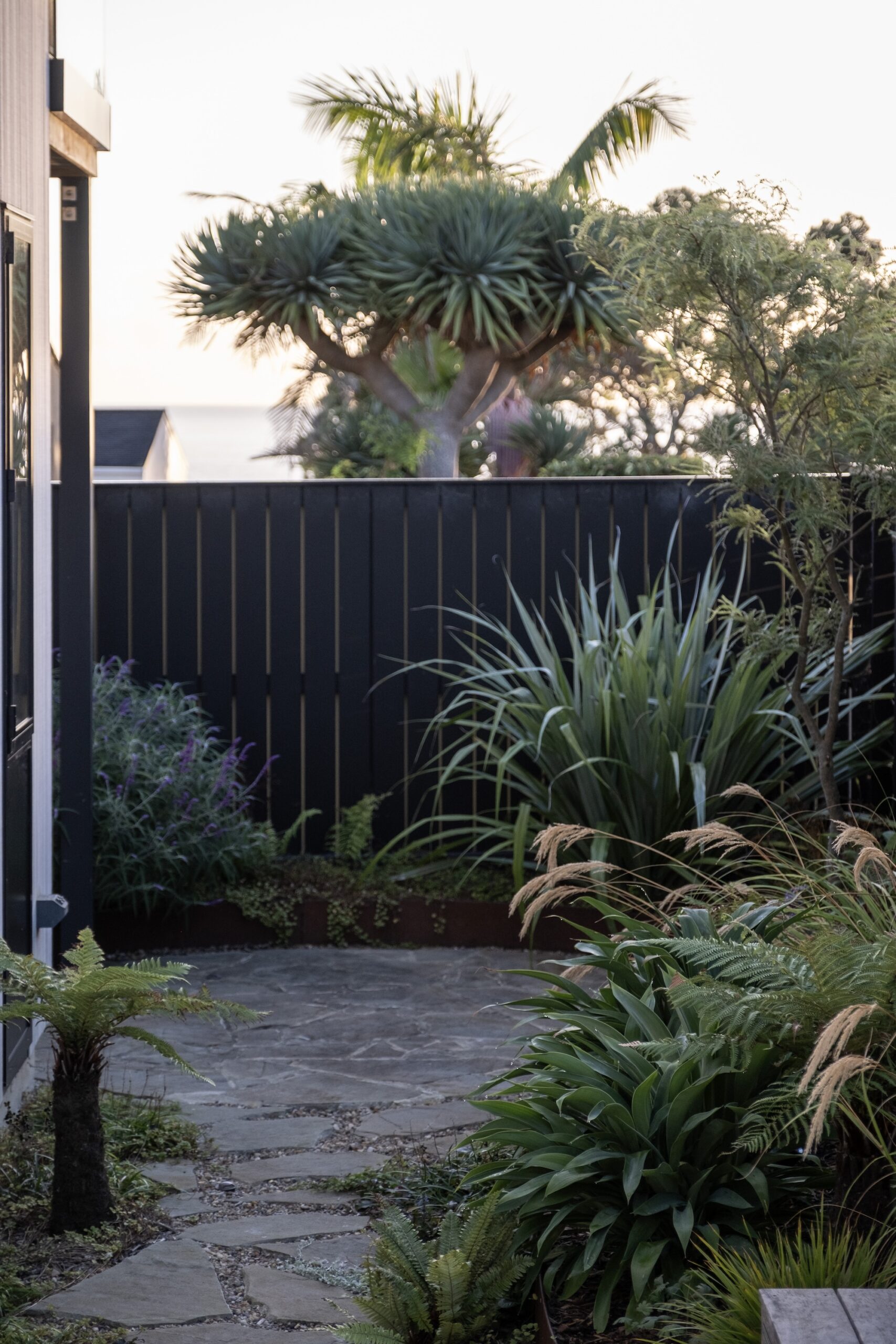 Entry gate leading into a minimalist modern landscape