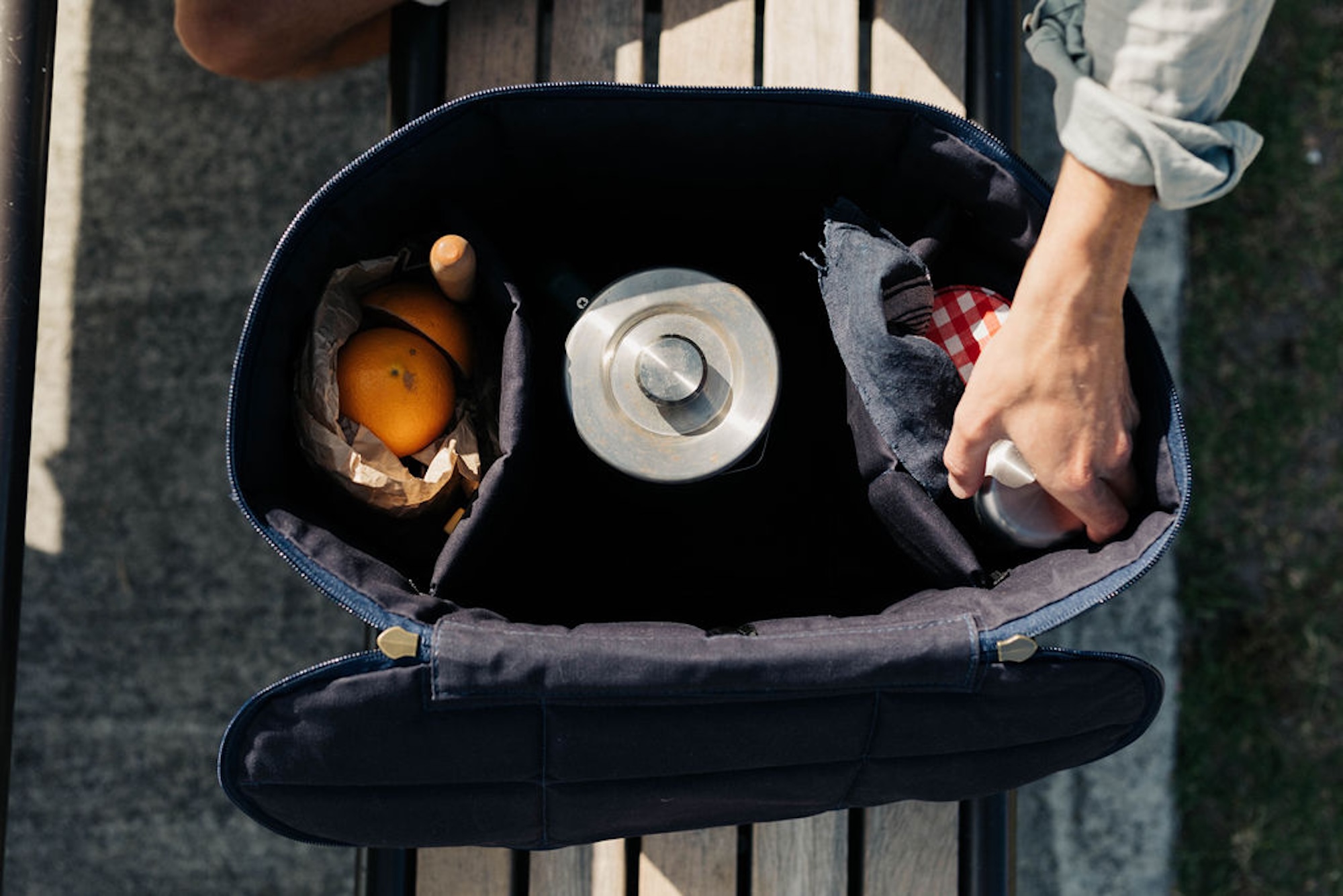 Susie’s Bags navy picnic bag packed with bread, fruit, and a kettle