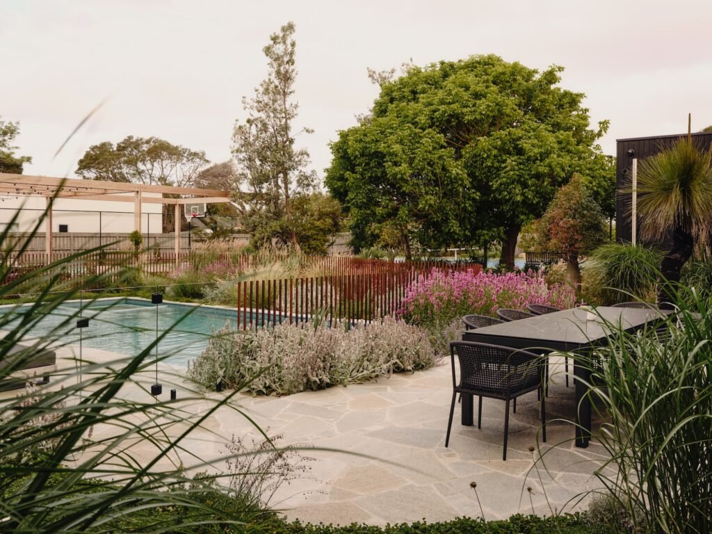 Poolside outdoor dining area surrounded by native and drought-tolerant planting – Phillip Withers