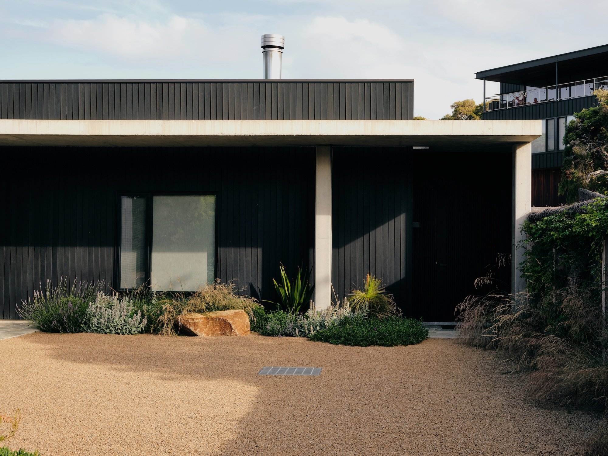 Contemporary home with poolside planting and integrated outdoor living spaces
