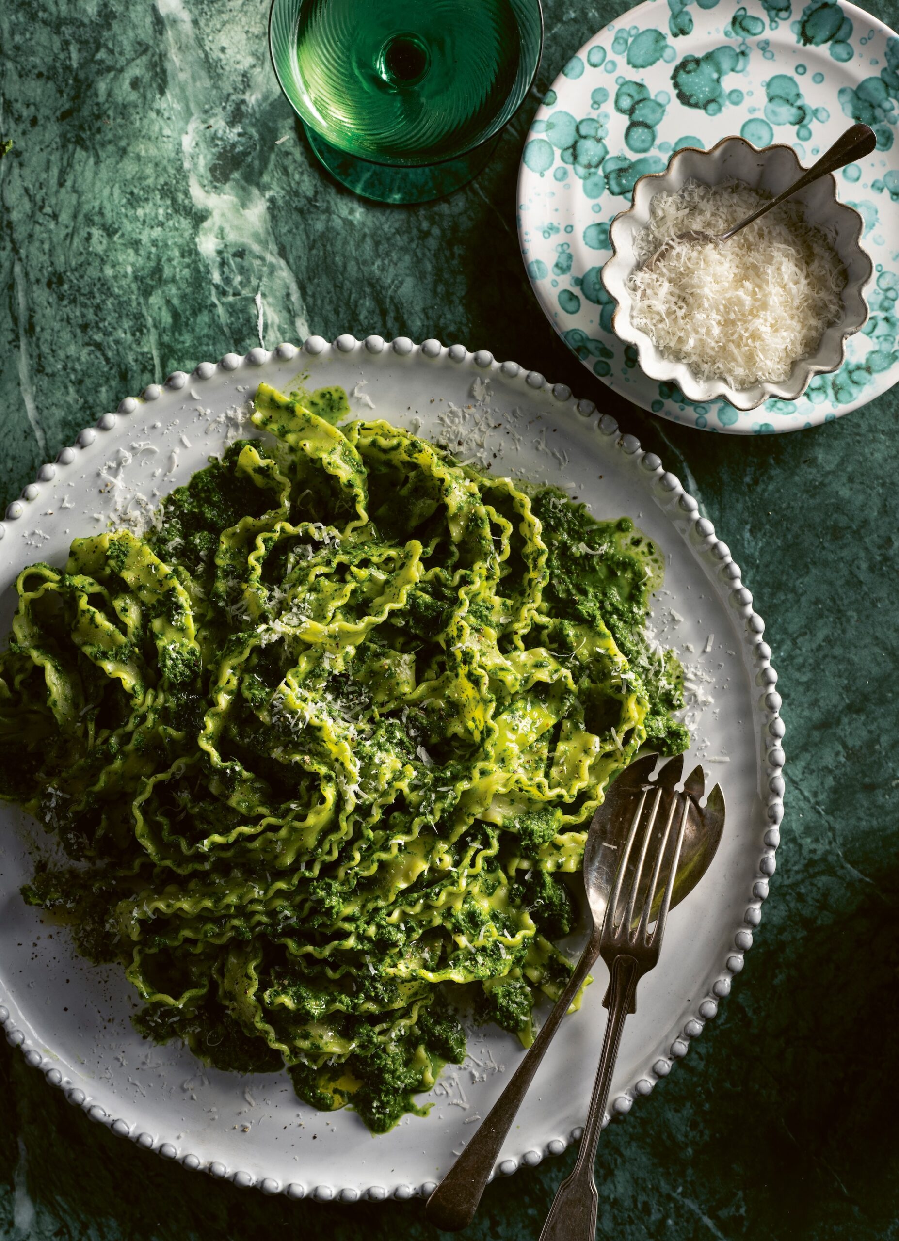 White plate with pasta and green herby dressing from Jane & Jimmy Barnes recipe book ‘Seasons Where the River Bends’