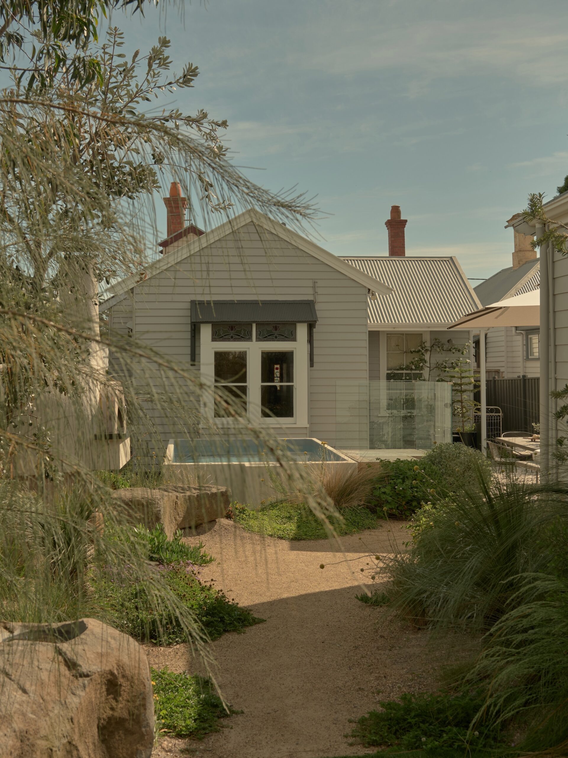 Garden Pathway Leading to Modern Home in Geelong Curved gravel pathway framed by soft greenery leading to a home in Phillip Withers Geelong garden