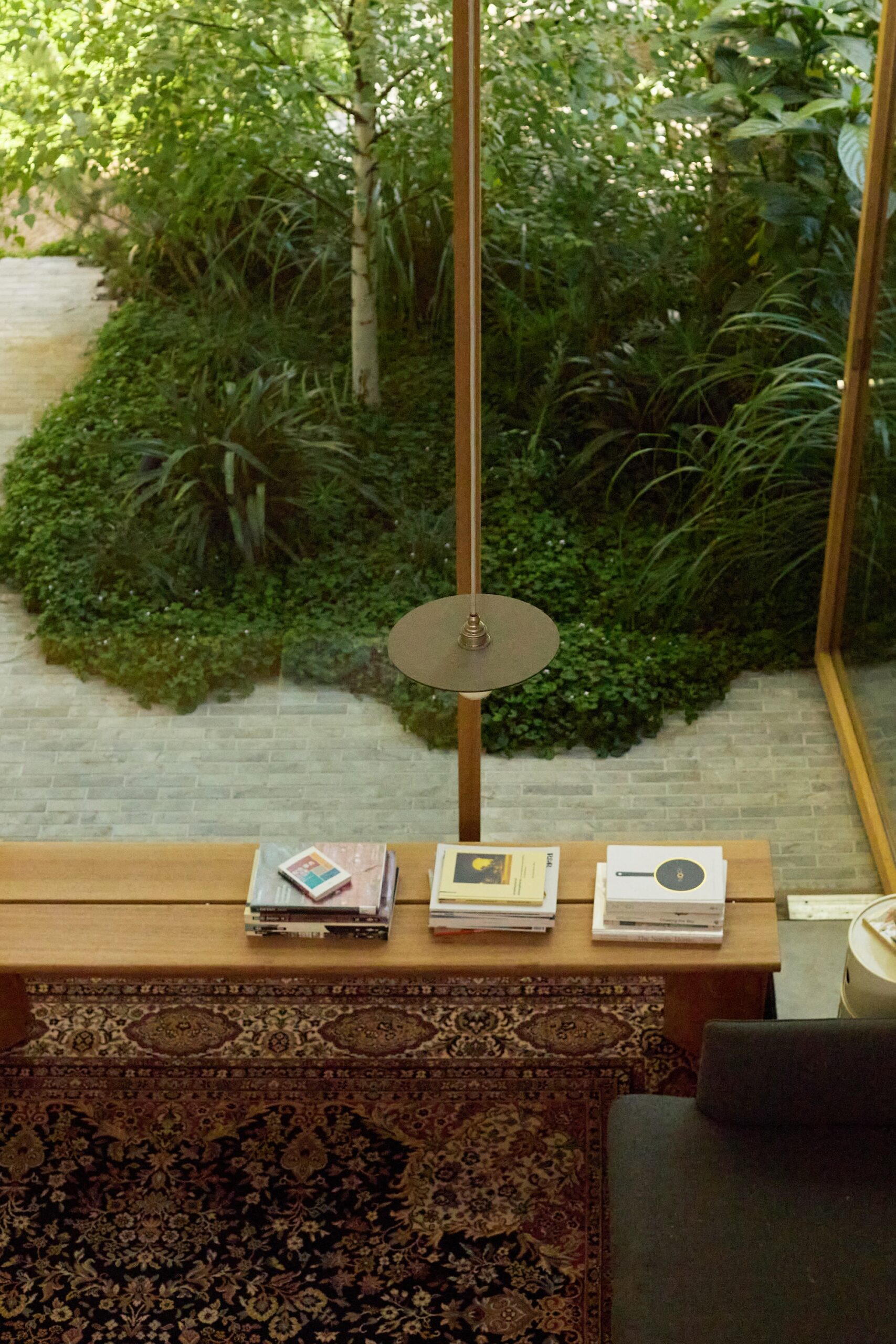 x Sculpted greenery border in courtyard by Jala, showcasing indoor-outdoor flow.