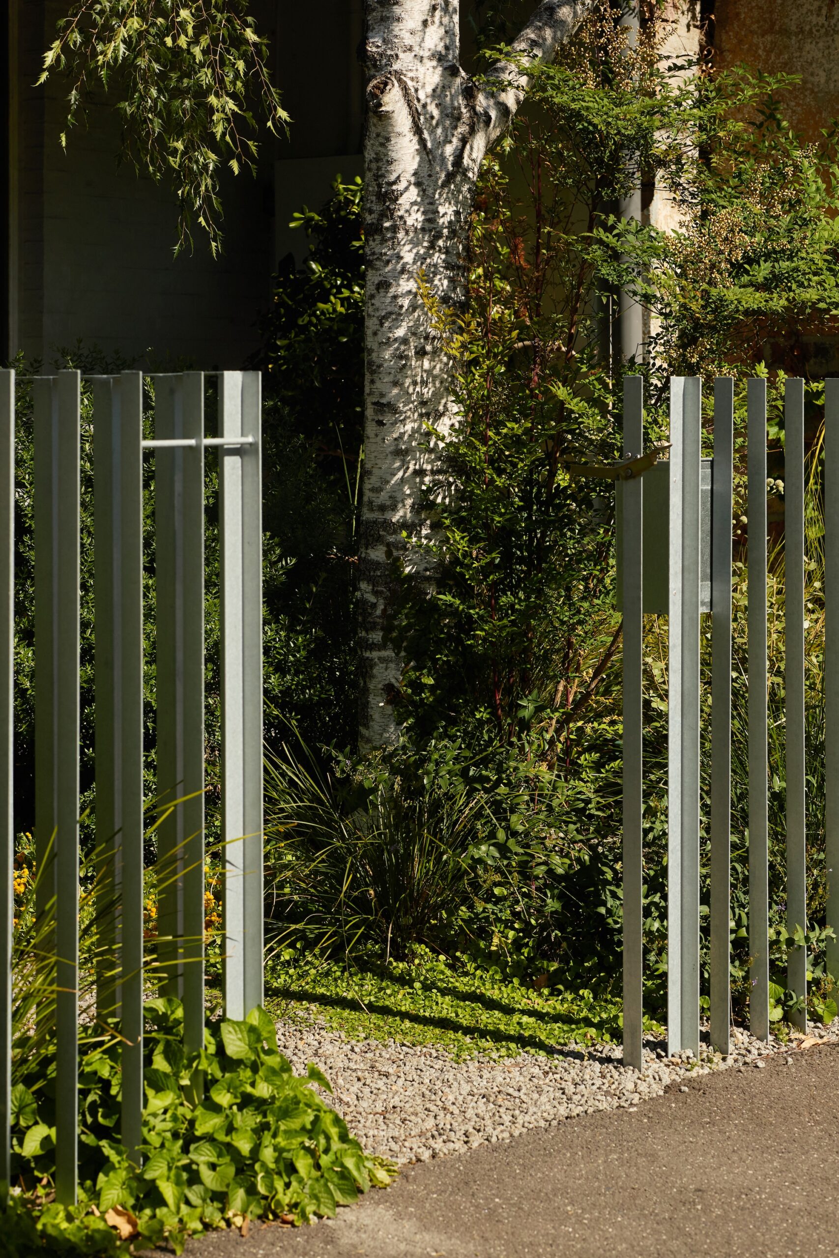 Vertical steel gate integrated with planting by Jala