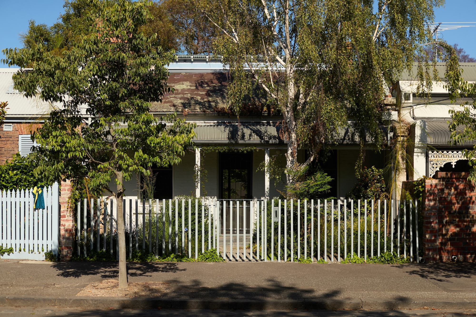 x Street-front landscape by Jala blending classic fencing and soft planting.