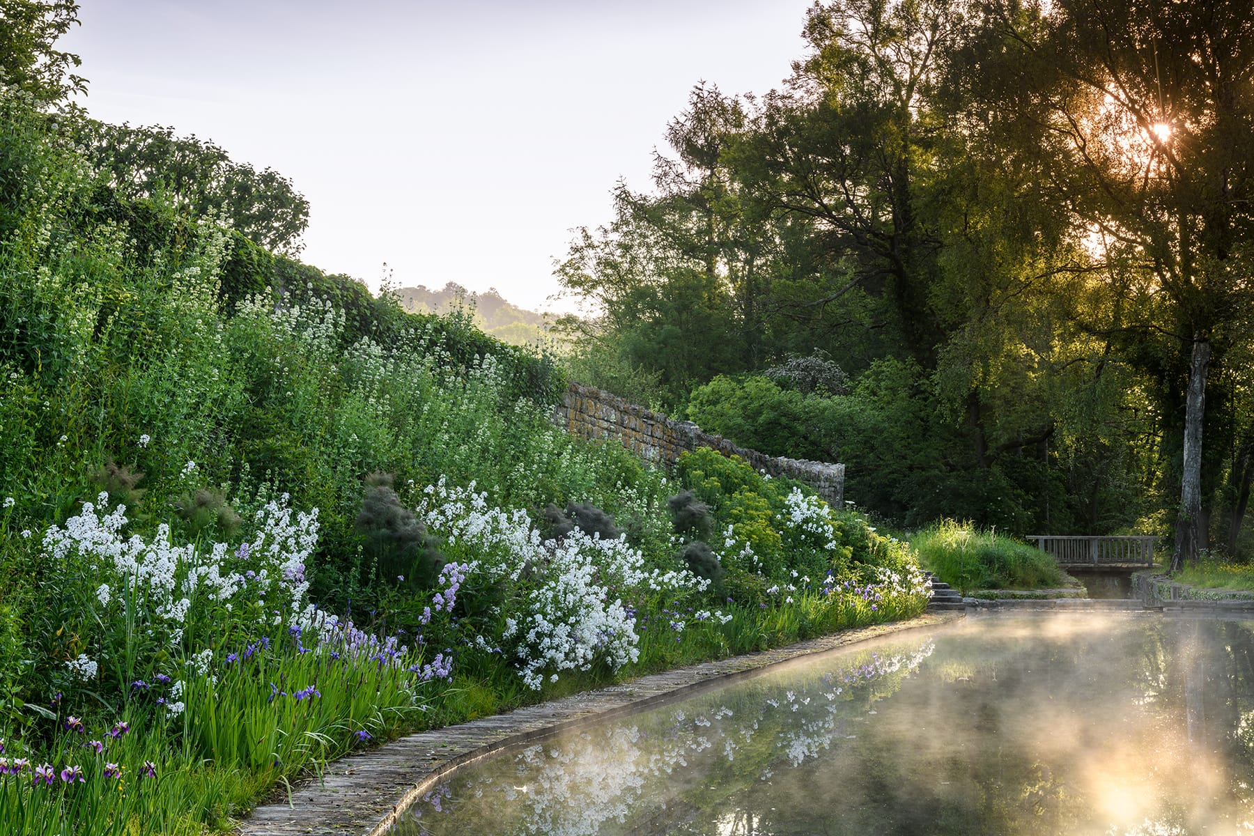 Garden Border – Caisson Gardens, Bath Layered flowering borders surrounding lake at Caisson House Garden, UK