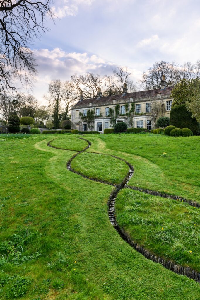 Curving mown lines through open lawn at Caisson House, Bath, UK