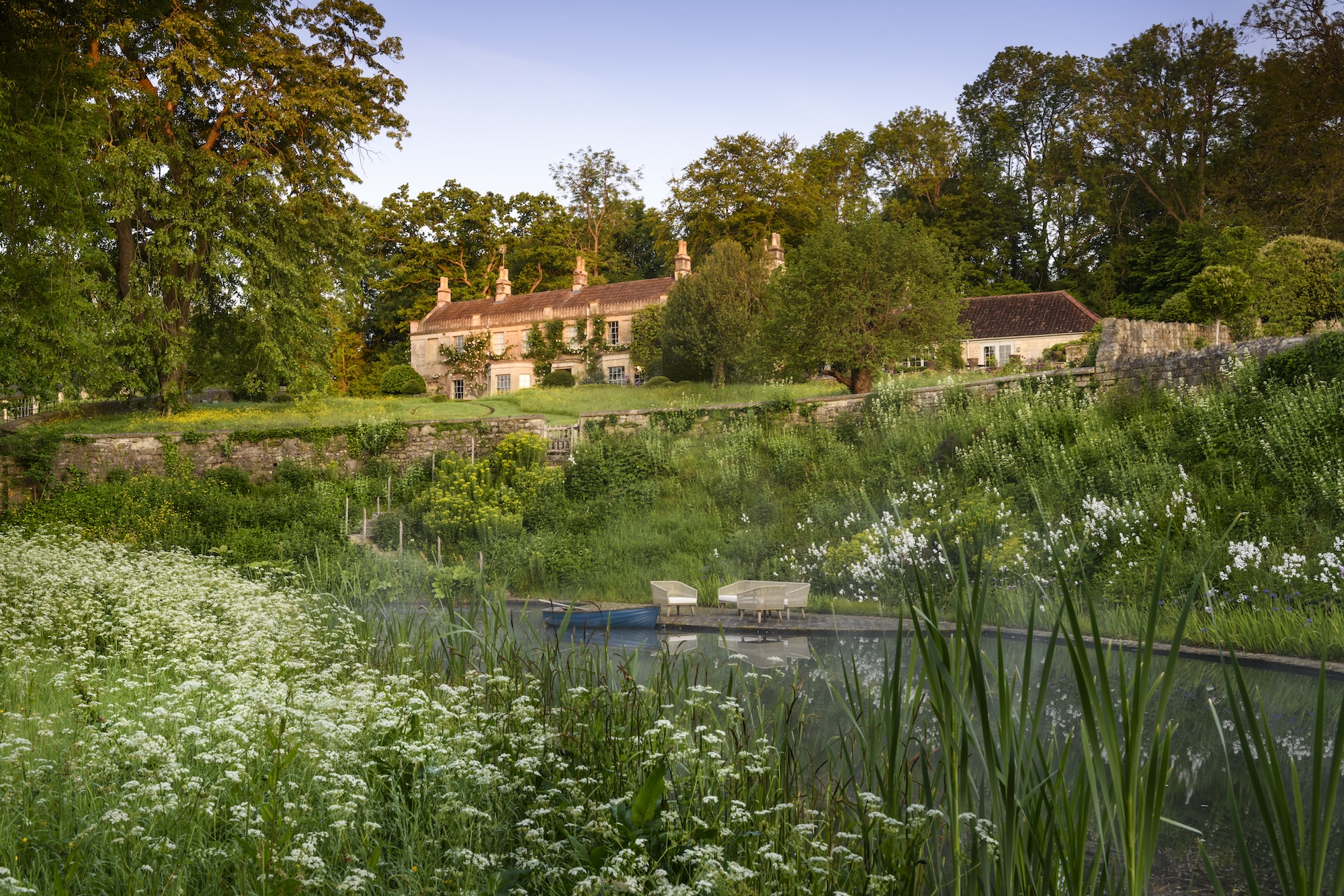 Caisson house overlooking layered planting of giant Camas, Iris, Fennel, Cow Parsley and Bulrush at Caisson Gardens in Bath