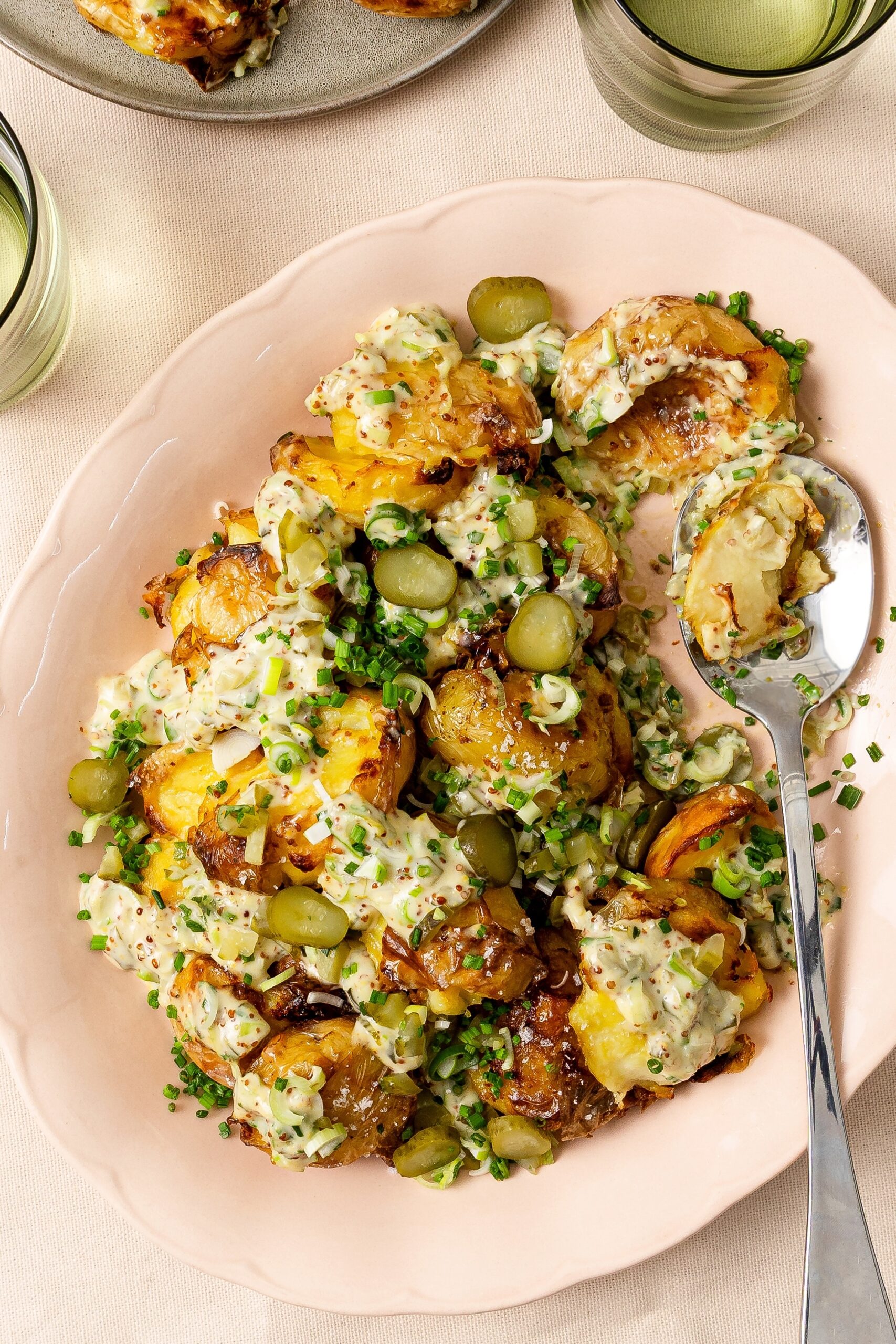 Potato salad served on plate served with herby dressing, recipe by Rhiannon Baldock