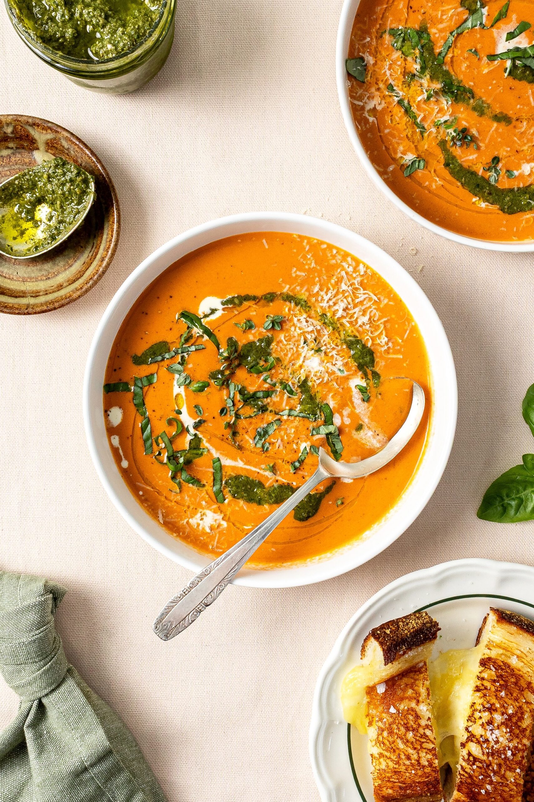 Creamy tomato soup served with creamy herby drizzle, recipe by Rhiannon Baldock