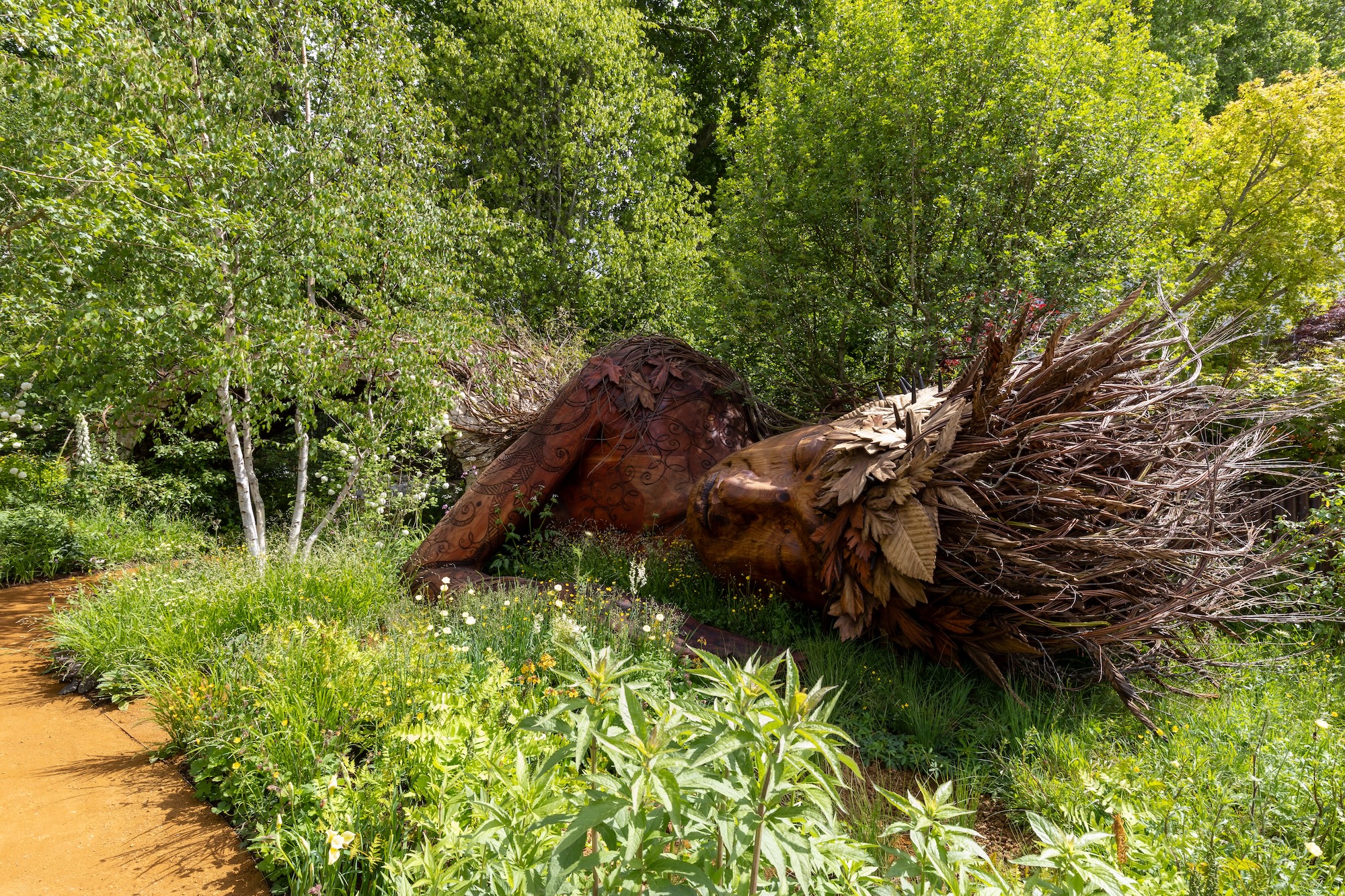1 Greek Earth Goddess Gaia sculpture nestled within naturalistic planting designed by Sarah Eberle for RHS CFS.