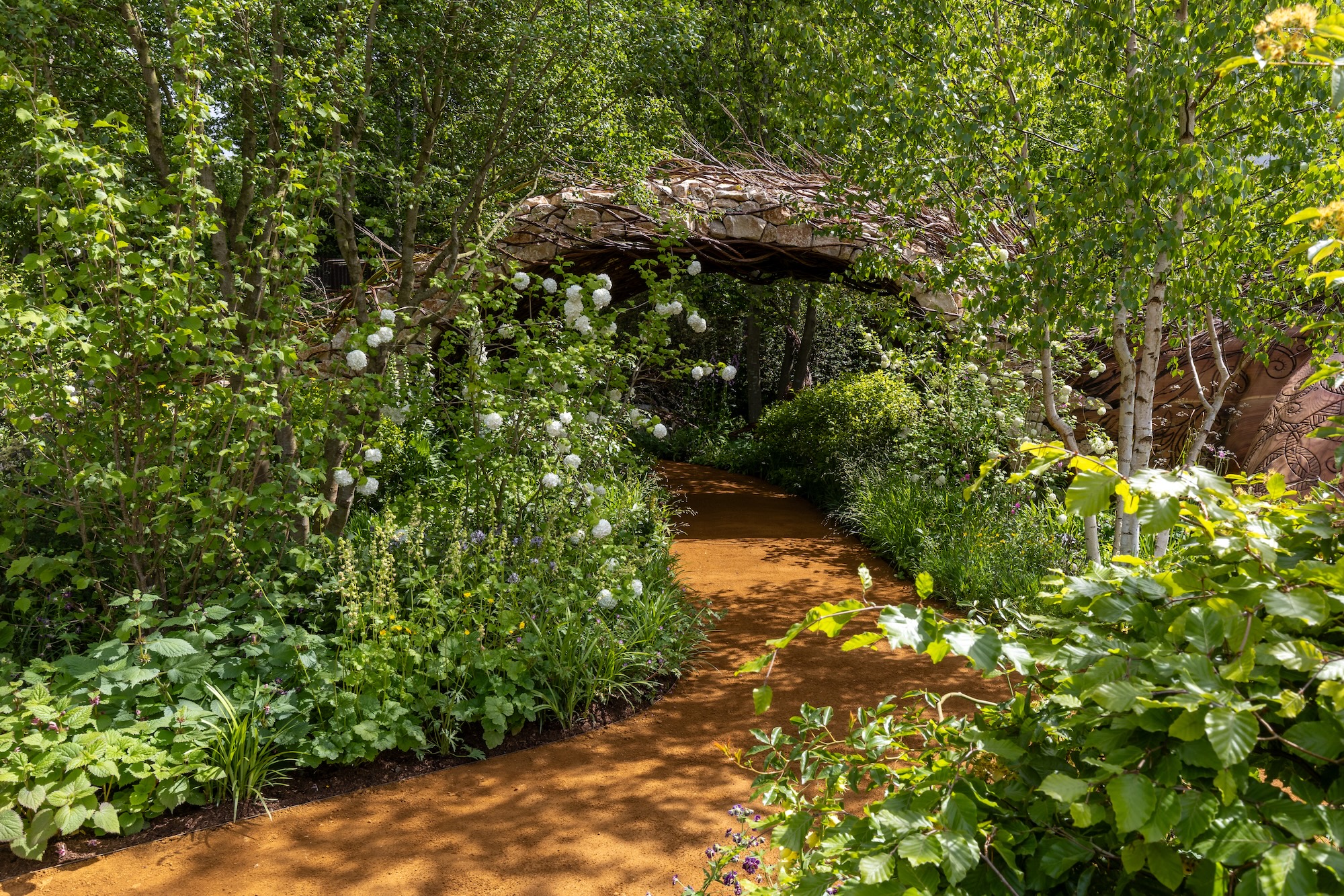 1 Leafy garden entrance surrounded by naturalistic planting inspired by the British countryside.
