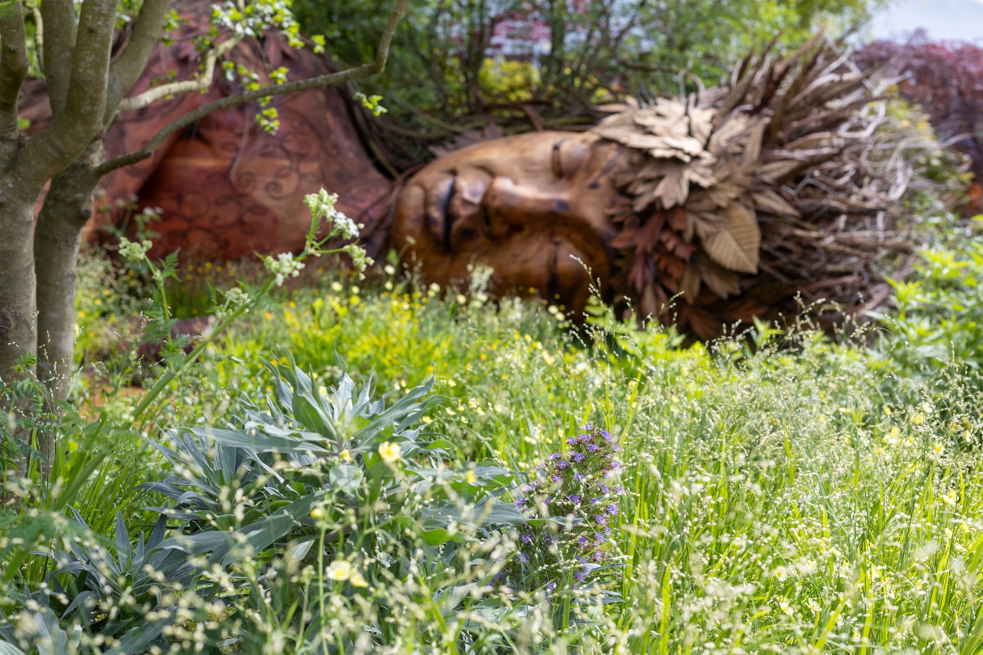 1 Naturalistic wildflower meadow surrounding a striking Greek Earth goddess Gaia sculptural installation by Sarah Eberle at RHS CFS.