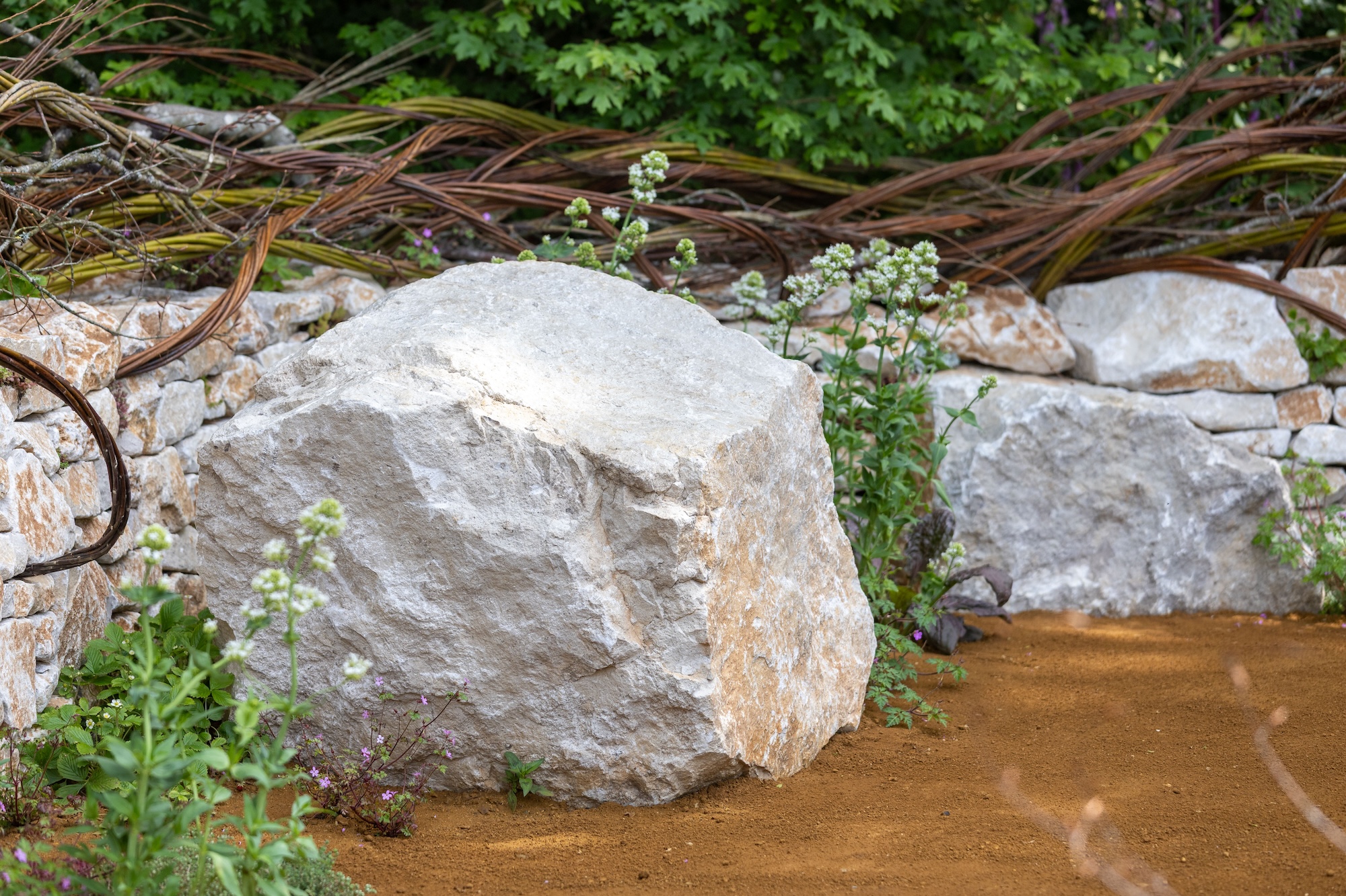 Natural stone boulder feature at RHS Chelsea Flower Show 1 Large stone boulder integrated into wildlife-friendly planting within The Campaign to Protect Rural England Garden.