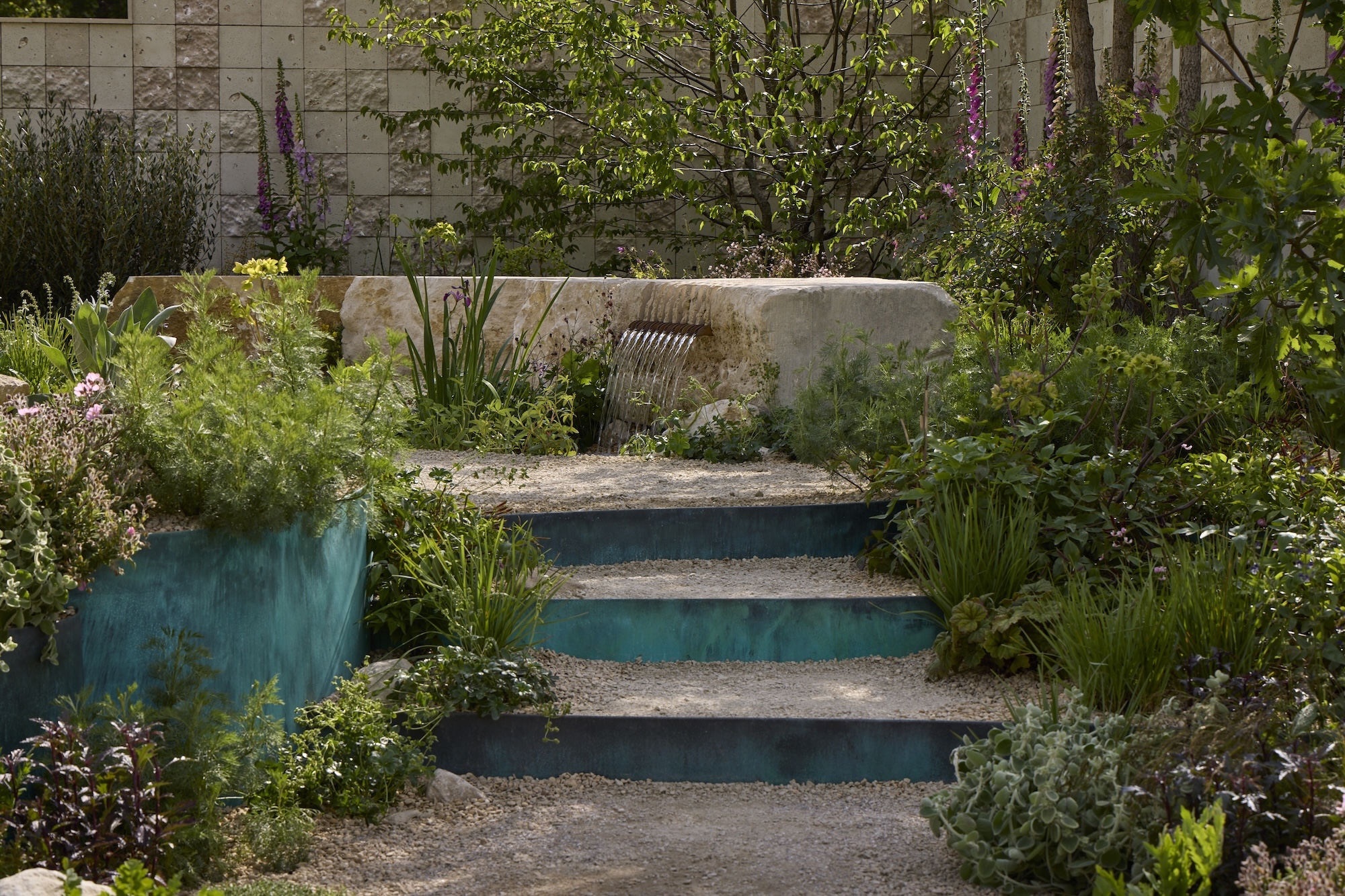 Mixed planting against turquoise steps in RHS CFS: Flourish in the City.