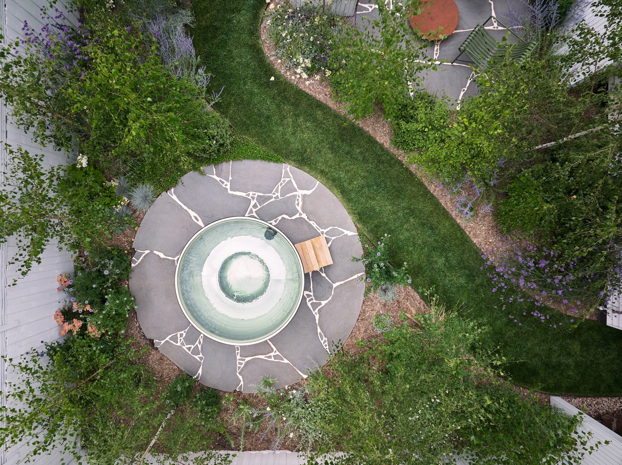 Circular paving feature in a landscaped Melbourne garden by Timeless Outdoors.