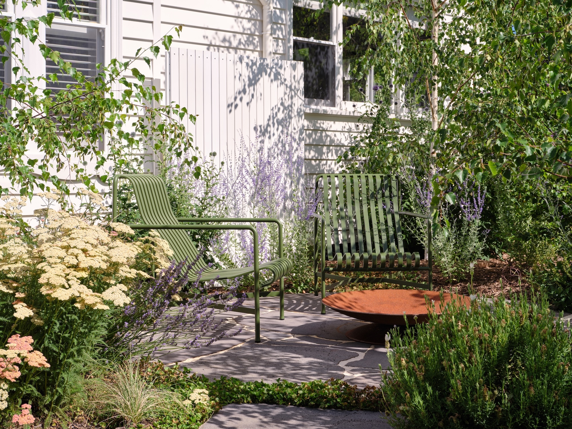 Courtyard garden with layered planting and outdoor seating by Timeless Outdoors in Melbourne, Australia
